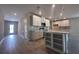 Bright, open kitchen featuring white cabinets, stainless steel appliances, and a center island with seating at 3660 Pandora Dr, Indian Lake Estates, FL 33855