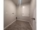 A utility room with a tile floor, a closet door, and connections for laundry equipment at 3660 Pandora Dr, Indian Lake Estates, FL 33855