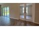 Home office area features glass French doors and wood-look tile flooring at 3660 Pandora Dr, Indian Lake Estates, FL 33855