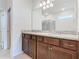 Bathroom featuring dual sinks with granite countertop and a shower in the background at 3751 Lana Ave, Davenport, FL 33897