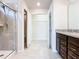 Bathroom featuring a tile shower with glass door, walk-in closet, and granite vanity at 3751 Lana Ave, Davenport, FL 33897