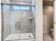 Bathroom showcasing tiled glass door shower and toilet with gray tile flooring at 3751 Lana Ave, Davenport, FL 33897