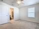 Bright bedroom featuring neutral carpeting, a ceiling fan, and one windows for natural light at 3751 Lana Ave, Davenport, FL 33897