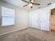 This bedroom features neutral walls, carpet flooring, ceiling fan, and a window with blinds at 3751 Lana Ave, Davenport, FL 33897