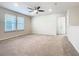 Spacious bedroom with neutral walls, carpet flooring, ceiling fan, and natural light from the windows at 3751 Lana Ave, Davenport, FL 33897