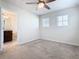 Bright bedroom featuring neutral carpeting, a ceiling fan, and two windows for natural light at 3751 Lana Ave, Davenport, FL 33897