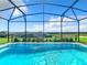 Stunning screened-in pool with gorgeous views of the surrounding community at 3751 Lana Ave, Davenport, FL 33897