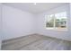 Bright, empty bedroom with a large window and wood-look floors at 41975 Aspen St, Eustis, FL 32736