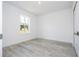 Bright bedroom featuring luxury vinyl plank flooring and a view through the window at 41975 Aspen St, Eustis, FL 32736