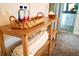 Decorated hallway with a wooden console table, towels, and a glimpse into the bathroom at 4289 Prologue Way, Kissimmee, FL 34746