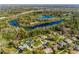 Aerial view of homes near a lake, highway and plenty of trees in the surrounding area at 4355 Watermill Ave, Orlando, FL 32817