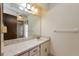 Bathroom with a large mirror, single sink vanity, and cabinet storage at 4355 Watermill Ave, Orlando, FL 32817