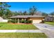 Charming single-story home featuring a well-manicured lawn and a two-car garage at 4355 Watermill Ave, Orlando, FL 32817