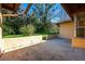 Outdoor patio with stucco wall, a covered seating area, and landscaping at 4355 Watermill Ave, Orlando, FL 32817