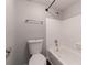 Bright bathroom with toilet, towel rack and tiled tub with shower at 4405 S Semoran Blvd # 7, Orlando, FL 32822