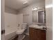 Bathroom with a white tiled tub, toilet, and vanity with granite countertop at 4405 S Semoran Blvd # 7, Orlando, FL 32822