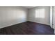 Bedroom with wood floors, a window and white walls at 4405 S Semoran Blvd # 7, Orlando, FL 32822