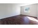 Empty bedroom with dark wood floors and large window for natural light at 4405 S Semoran Blvd # 7, Orlando, FL 32822