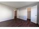 Bedroom featuring wood floors, closet and a bathroom entrance at 4405 S Semoran Blvd # 7, Orlando, FL 32822