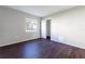 A bright bedroom with a large window, closet, and modern flooring at 4405 S Semoran Blvd # 7, Orlando, FL 32822