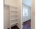 Walk-in closet featuring shelves, white walls and wood floors at 4405 S Semoran Blvd # 7, Orlando, FL 32822