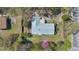 Aerial view of house showing lawn, mature trees, and metal roof at 4898 Meadow Dr, St Cloud, FL 34772