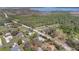 Gorgeous aerial view showing neighborhood homes surrounded by mature trees and roads with easy access to a lake at 4898 Meadow Dr, St Cloud, FL 34772