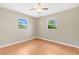 Bedroom with neutral walls, wood floor and two double hung windows at 4898 Meadow Dr, St Cloud, FL 34772