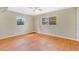 Spacious bedroom with hardwood floors, neutral walls, and bright windows at 4898 Meadow Dr, St Cloud, FL 34772