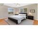 Comfortable bedroom with two windows, a ceiling fan, and neutral decor at 4898 Meadow Dr, St Cloud, FL 34772