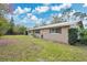 Well-kept single-story home with a metal roof and a spacious, green yard at 4898 Meadow Dr, St Cloud, FL 34772