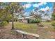 Exterior view of house and backyard with brick fire pit and bench at 4898 Meadow Dr, St Cloud, FL 34772