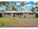 A quaint one-story house with simple landscaping and a durable metal roof at 4898 Meadow Dr, St Cloud, FL 34772