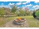 Backyard with brick fire pit, chairs and mature trees at 4898 Meadow Dr, St Cloud, FL 34772