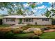 Charming single-story home featuring a landscaped front yard with native plants and stepping stone pathway at 4898 Meadow Dr, St Cloud, FL 34772