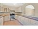 Functional kitchen with white cabinets, tile countertops, and stainless steel appliances at 4898 Meadow Dr, St Cloud, FL 34772