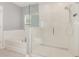 A stylish bathroom with a glass-enclosed shower and a separate soaking tub at 515 Darshire Ave, Eustis, FL 32736