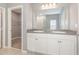 A modern bathroom featuring a double sink vanity and open access to a large closet at 515 Darshire Ave, Eustis, FL 32736