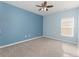 A well lit bedroom with carpet, ceiling fan and a double hung window at 515 Darshire Ave, Eustis, FL 32736