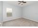 Cozy bedroom featuring neutral walls, carpet flooring, and a window at 515 Darshire Ave, Eustis, FL 32736