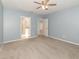 A well lit bedroom with an open door to the bathroom and hallway at 515 Darshire Ave, Eustis, FL 32736