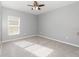 A bright bedroom with neutral paint and carpet and a window at 515 Darshire Ave, Eustis, FL 32736