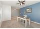 Bright office space with a writing desk, ceiling fan and a blue accent wall at 515 Darshire Ave, Eustis, FL 32736