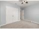 Clean bedroom features a ceiling fan, light blue walls, and carpet flooring at 515 Darshire Ave, Eustis, FL 32736