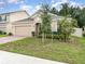 Single-story home with a brick driveway, lush lawn, and minimal landscaping at 515 Darshire Ave, Eustis, FL 32736