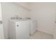 Functional laundry room with a white washer and dryer set, plus wire shelving at 515 Darshire Ave, Eustis, FL 32736