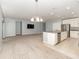 Open living space with kitchen island, stainless steel appliances, and dining area at 515 Darshire Ave, Eustis, FL 32736