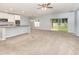 Expansive living space with carpet, a modern kitchen, and sliding glass door at 515 Darshire Ave, Eustis, FL 32736