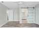 Bedroom featuring wood-look floors, light green walls, and bathroom with sliding door at 517 Seville Ave, Altamonte Springs, FL 32714