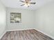 Bedroom with hardwood floors, ceiling fan, and a window overlooking the front yard at 517 Seville Ave, Altamonte Springs, FL 32714